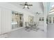 Covered patio with ceiling fans overlooks a screened-in pool with sliding glass doors at 5819 Ne 72Nd St, Silver Springs, FL 34488