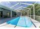 Large screened-in pool area with ample patio space and backyard views at 5819 Ne 72Nd St, Silver Springs, FL 34488