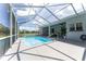 Screened-in pool area with patio, palm tree, and exterior home view at 5819 Ne 72Nd St, Silver Springs, FL 34488