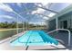 Clear blue screened in pool with surrounding greenery and seating area at 5819 Ne 72Nd St, Silver Springs, FL 34488