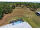 Aerial view of an enclosed in-ground pool with clean blue water on a sunny day at 5819 Ne 72Nd St, Silver Springs, FL 34488