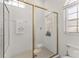 This bathroom features a spacious shower with gold trim and a glass door at 5819 Ne 72Nd St, Silver Springs, FL 34488