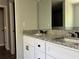 Bathroom vanity with double sinks, white cabinets, and a granite countertop at 6101 Sw 206Th Ave, Dunnellon, FL 34431