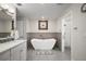 Elegant bathroom featuring a freestanding tub and a glass-enclosed shower at 6292 Se 13Th St, Ocala, FL 34472
