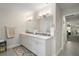 Modern bathroom featuring double vanity sinks, a large mirror, and neutral tones at 6292 Se 13Th St, Ocala, FL 34472