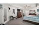 Large bedroom with tray ceiling, a king bed, and a chest of drawers at 6292 Se 13Th St, Ocala, FL 34472