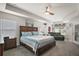 Spacious bedroom with tray ceiling, a king bed, and a sitting area at 6292 Se 13Th St, Ocala, FL 34472
