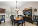Dining room featuring a chandelier and natural light from a large window at 6292 Se 13Th St, Ocala, FL 34472