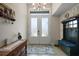 Inviting foyer featuring a decorative rug, chandelier, bench and complemented by natural light at 6292 Se 13Th St, Ocala, FL 34472
