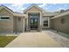 Charming front entrance with stone accents, a double door, and cozy rocking chairs at 6292 Se 13Th St, Ocala, FL 34472