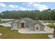 Stunning gray home with a well-manicured lawn and a spacious driveway, plus a fenced backyard with a pool at 6292 Se 13Th St, Ocala, FL 34472