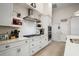 Kitchen boasting white cabinets, stainless steel appliances, and a herringbone backsplash at 6292 Se 13Th St, Ocala, FL 34472