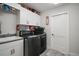 Functional laundry room with white cabinets, a sink, and modern washer and dryer at 6292 Se 13Th St, Ocala, FL 34472