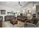 Open-concept living room flowing into the kitchen and dining area, featuring plush seating and modern decor at 6292 Se 13Th St, Ocala, FL 34472