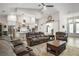 Open-concept living room with vaulted ceilings, ceiling fan, and a view of the kitchen at 6292 Se 13Th St, Ocala, FL 34472