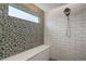 Stylish shower with white subway tile and an accent wall of mosaic tile at 6292 Se 13Th St, Ocala, FL 34472