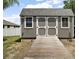 Charming storage shed with double doors and ramp, perfect for storing tools, equipment, or outdoor toys at 6292 Se 13Th St, Ocala, FL 34472