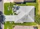 An aerial view showcases the home's roof, landscaping, driveway, and street at 680 Farmington Ave, The Villages, FL 32162