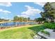 Landscaped backyard with palm trees and beautiful lake view at 680 Farmington Ave, The Villages, FL 32162