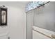 Bathroom featuring a glass shower door, framed print, and towel bar at 680 Farmington Ave, The Villages, FL 32162