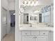 Bathroom featuring a vanity with storage and a view into another room at 680 Farmington Ave, The Villages, FL 32162