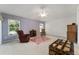 Large bedroom with neutral color scheme and furniture at 680 Farmington Ave, The Villages, FL 32162