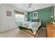 Bedroom featuring a bamboo headboard and green accent wall at 680 Farmington Ave, The Villages, FL 32162