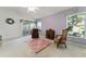 Bedroom with chair and door to the patio at 680 Farmington Ave, The Villages, FL 32162
