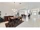 Elegant dining room with a chandelier, stylish furnishings, and an open view to the kitchen at 680 Farmington Ave, The Villages, FL 32162