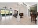 Open-concept dining area featuring tile flooring, decorative columns, and seamless access to the lanai at 680 Farmington Ave, The Villages, FL 32162