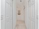 Hallway with linen closet at 680 Farmington Ave, The Villages, FL 32162