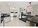 Open-concept kitchen with island and breakfast bar that looks into the dining area at 680 Farmington Ave, The Villages, FL 32162