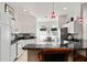 Bright kitchen featuring white cabinetry, granite countertops, and a breakfast bar with seating at 680 Farmington Ave, The Villages, FL 32162