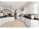 Bright kitchen featuring white cabinetry, black granite countertops, and stainless steel appliances at 680 Farmington Ave, The Villages, FL 32162