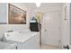 Laundry room with washer, dryer, utility sink, and storage area at 680 Farmington Ave, The Villages, FL 32162