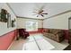 Living room featuring natural light, a ceiling fan, and a sitting area at 680 Farmington Ave, The Villages, FL 32162