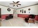 Carpeted living room with decorative wallpaper and furnishings at 680 Farmington Ave, The Villages, FL 32162