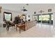 Cozy living room with a fireplace, tile flooring, comfortable seating, and sliding glass doors to the lanai at 680 Farmington Ave, The Villages, FL 32162