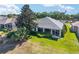 Well-maintained backyard with a screen enclosed lanai and mature landscaping at 680 Farmington Ave, The Villages, FL 32162