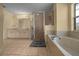 A spacious bathroom featuring a shower, tub, and double sink vanity at 7370 Sw 129Th Ln, Ocala, FL 34473