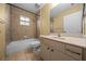 Neutral bathroom features a tub/shower combo and a vanity with ample storage at 7370 Sw 129Th Ln, Ocala, FL 34473