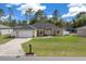 Charming single-story home with a well-manicured lawn, a two-car garage and mature landscaping at 7370 Sw 129Th Ln, Ocala, FL 34473