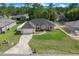 Charming single-story home with a well-manicured lawn, a two-car garage and mature landscaping at 7370 Sw 129Th Ln, Ocala, FL 34473