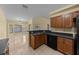 A cozy kitchen features wood cabinets, a double sink, and a view into the dining area at 7370 Sw 129Th Ln, Ocala, FL 34473