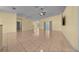Spacious living room with tile floors, neutral walls, and a ceiling fan for modern comfort at 7370 Sw 129Th Ln, Ocala, FL 34473
