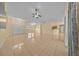 Expansive living space featuring neutral walls, tile flooring, a ceiling fan, and natural light at 7370 Sw 129Th Ln, Ocala, FL 34473