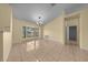 Inviting living room features tile floors, neutral walls, bright bay window, and elegant lighting at 7370 Sw 129Th Ln, Ocala, FL 34473