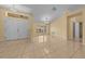Open living area features tile floors, neutral walls, bay window, chandelier, and ample space at 7370 Sw 129Th Ln, Ocala, FL 34473