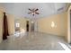 Spacious primary bedroom boasting tile floors, ceiling fan, and access to an ensuite bathroom at 7370 Sw 129Th Ln, Ocala, FL 34473