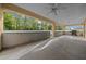 Covered outdoor patio with a ceiling fan and space for entertaining with a grill at 7370 Sw 129Th Ln, Ocala, FL 34473